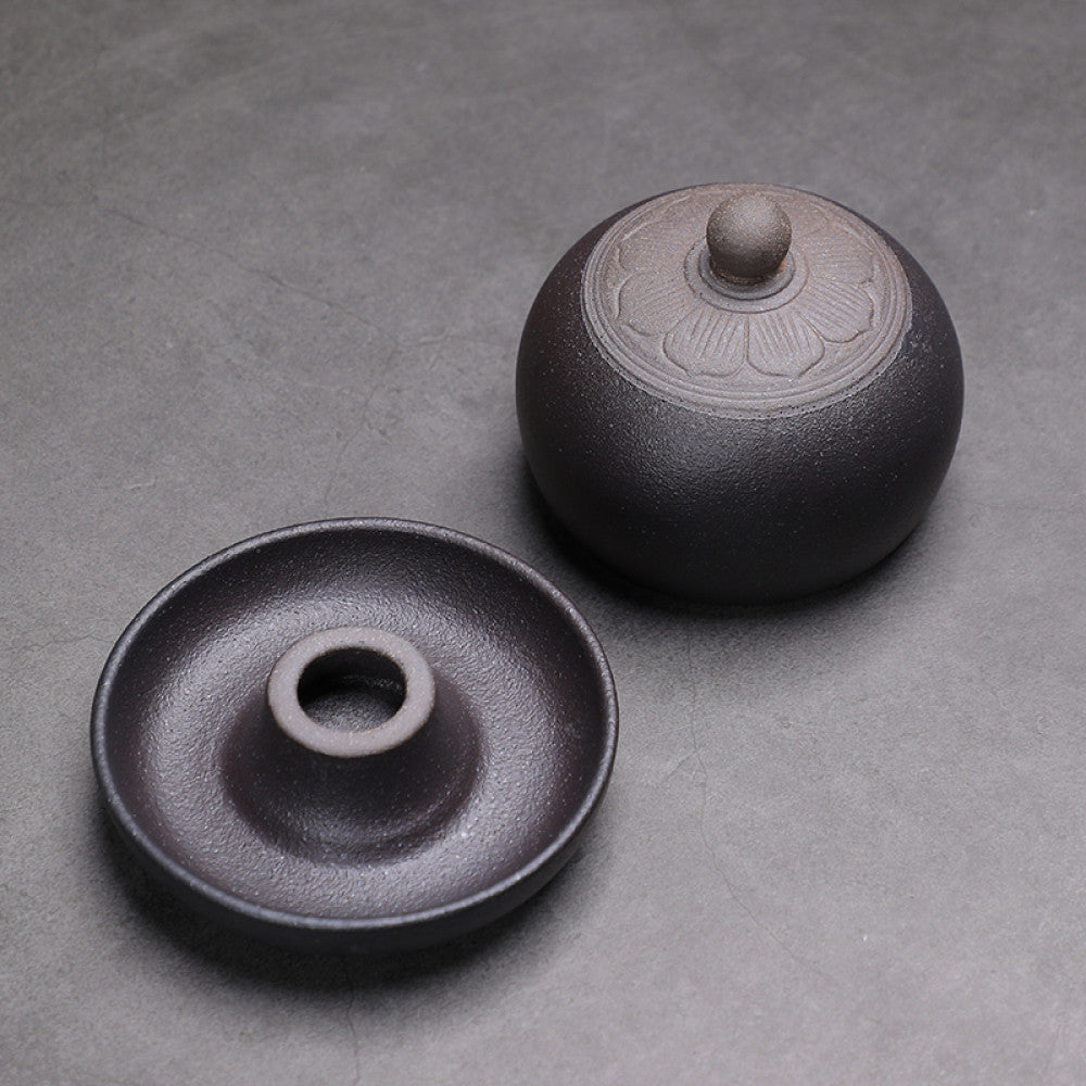 Deckel und Untertasse in Schwarz mit rundem Ausguss. Minimalistische Formen und hochwertige Keramik.